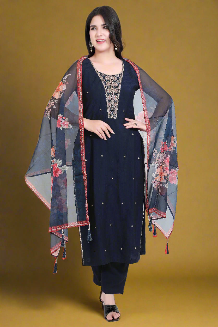 Woman wearing a navy blue kurta with a floral dupatta in a minimalistic setting